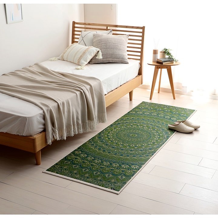 Green Mandala igusa yoga mat in a bedroom